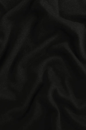 Close-up of the jet black linen–Supima blend fabric, highlighting breathable comfort and soft hand feel.