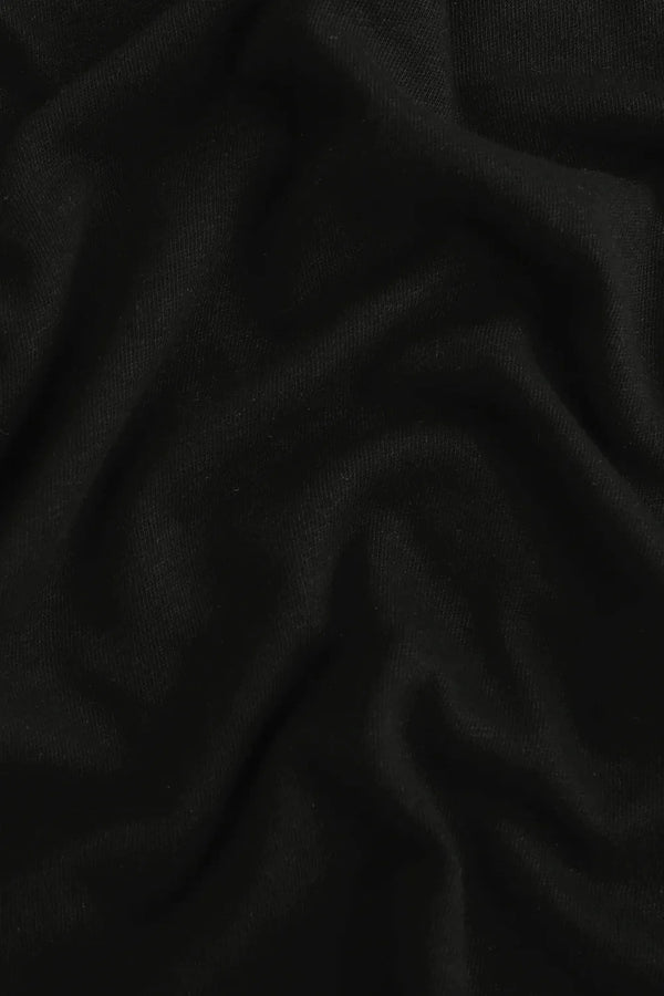 Close-up of the jet black linen–Supima blend fabric, highlighting breathable comfort and soft hand feel.