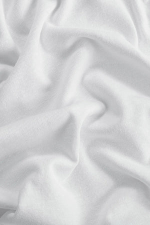 Close-up of the pure white linen–Supima blend fabric, highlighting breathable comfort and soft texture.