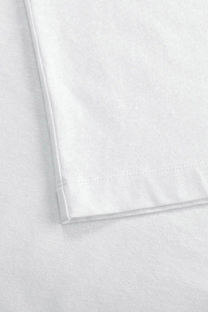 Detail of the hem finish on a men’s pure white linen–Supima crewneck tee.