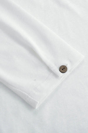 Detail view of the single-button cuff on a men’s alpine white linen–Supima henley, designed for clean everyday ease.