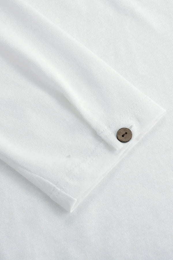 Detail view of the single-button cuff on a men’s alpine white linen–Supima henley, designed for clean everyday ease.