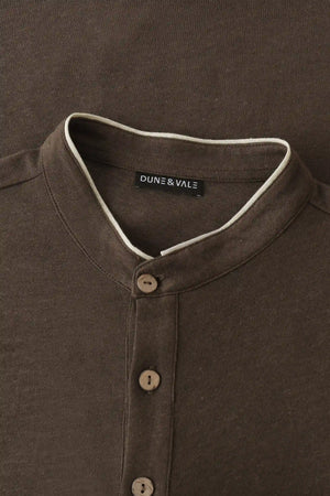 Close-up of the button-neck mandarin collar on a men’s espresso linen–Supima henley.