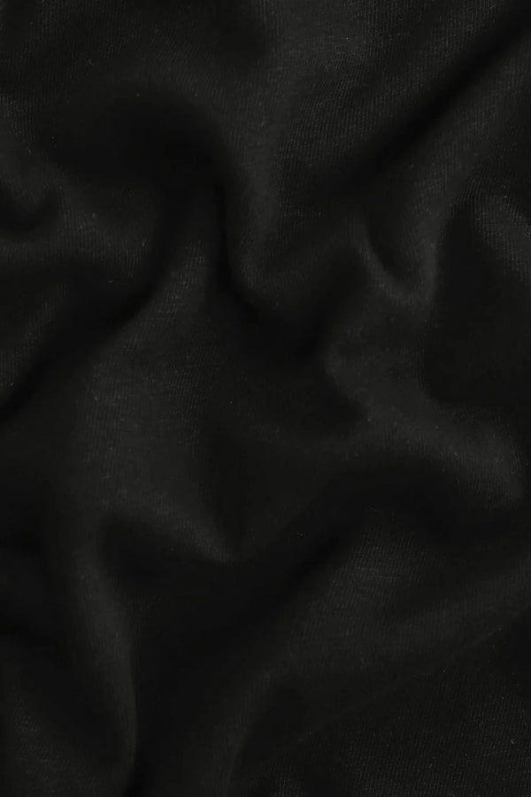 Close-up of the onyx black linen–Supima blend fabric, highlighting breathable texture and soft hand feel.