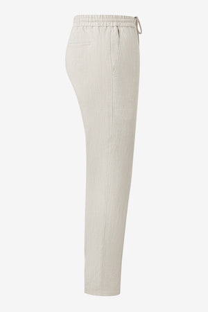 3D side view of men’s driftwood beige linen-Tencel drawstring trousers highlighting an easy, breathable silhouette.