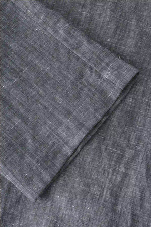Close-up of the hem finish on men’s heather grey linen-Tencel drawstring trousers, showing a relaxed straight-leg cut.