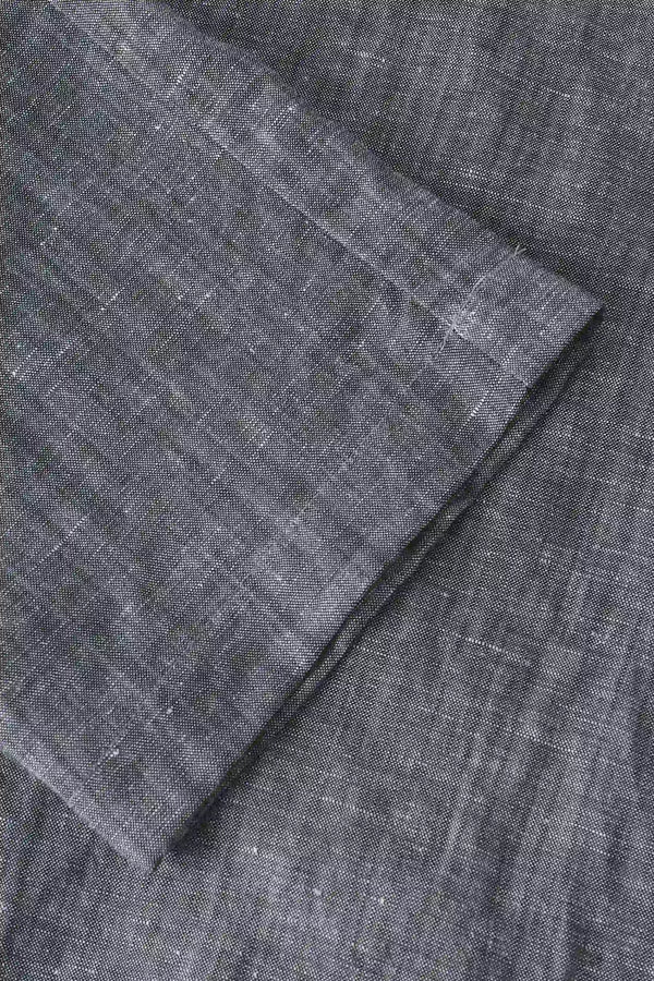 Close-up of the hem finish on men’s heather grey linen-Tencel drawstring trousers, showing a relaxed straight-leg cut.