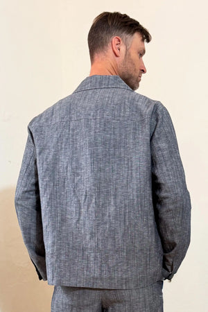 Back view of a men’s heather grey linen-Tencel safari jacket with a clean, tailored finish.
