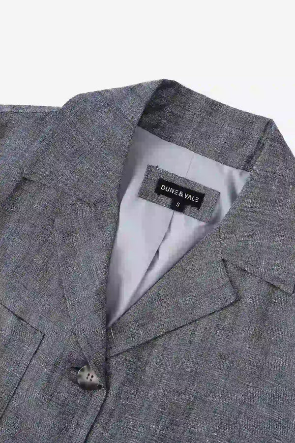 Close-up of the notched collar on a men’s heather grey linen-Tencel safari jacket.
