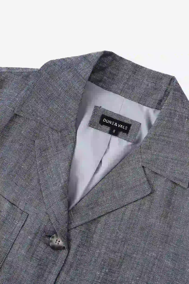 Close-up of the notched collar on a men’s heather grey linen-Tencel safari jacket.