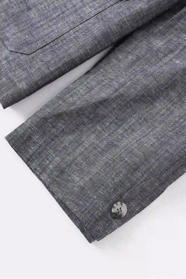 Detail view of the sleeve construction on a men’s heather grey linen-Tencel safari jacket.