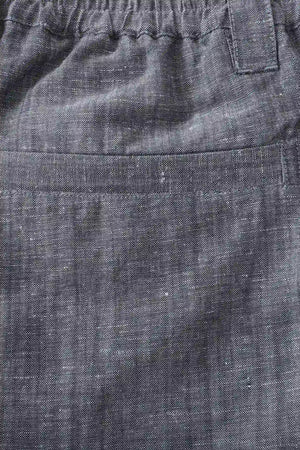 Detail view of the back pocket on men’s heather grey linen-Tencel tailored shorts, keeping a clean tailored look.