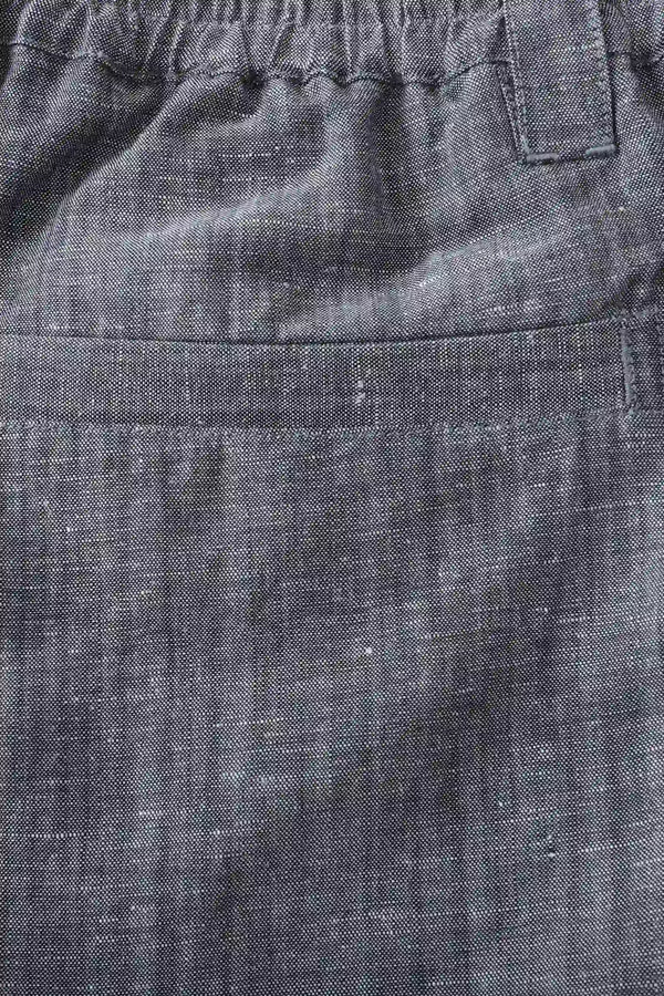 Detail view of the back pocket on men’s heather grey linen-Tencel tailored shorts, keeping a clean tailored look.