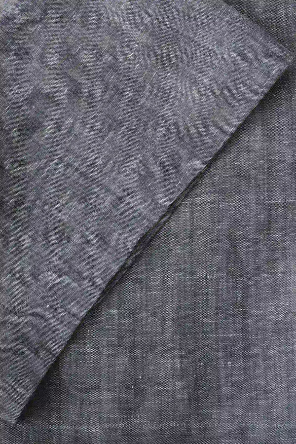 Close-up of the hem finish on men’s heather grey linen-Tencel tailored shorts, showing a clean, modern cut.