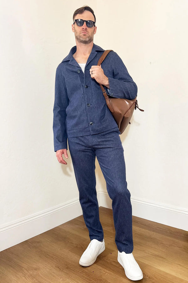 Men’s indigo rinse structured denim trousers styled with a matching denim jacket for a cohesive, modern denim look.