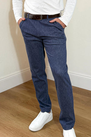 Front view of men’s structured denim trousers in indigo rinse, styled with a white top for a clean, polished look.