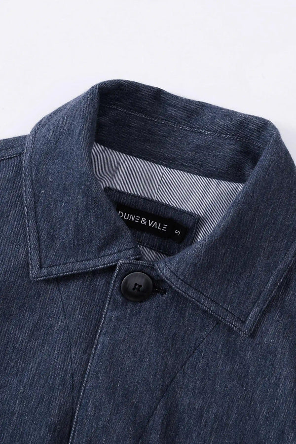 Close-up of the collar detail on a men’s indigo rinse utility denim overshirt jacket.