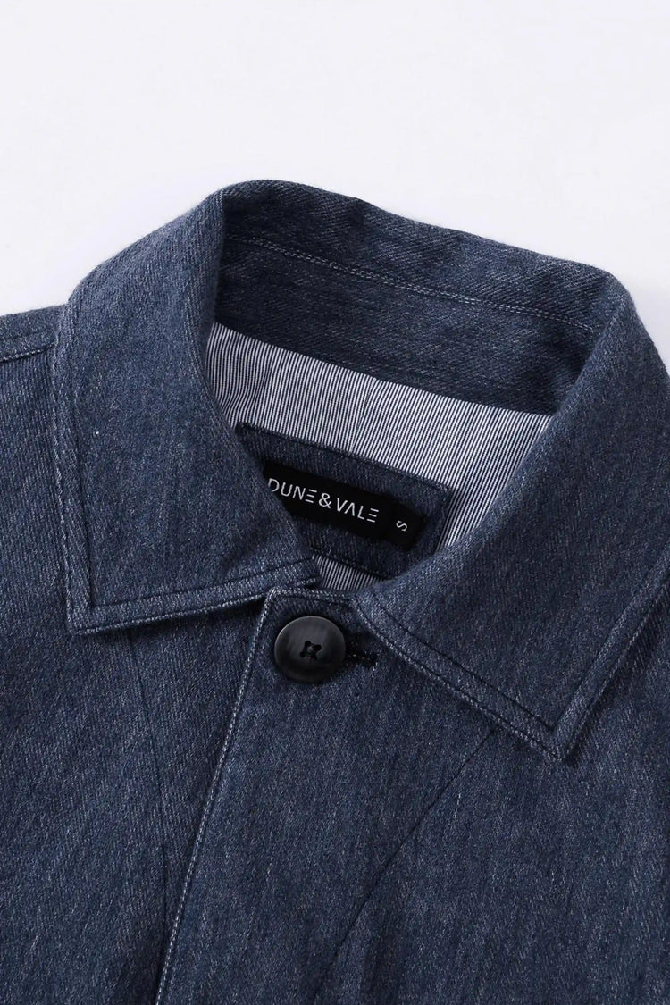 Close-up of the collar detail on a men’s indigo rinse utility denim overshirt jacket.