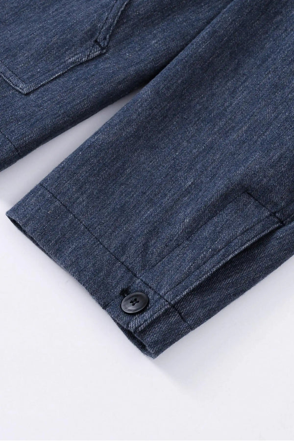 Detail view of the sleeve construction on a men’s indigo rinse utility denim overshirt jacket.