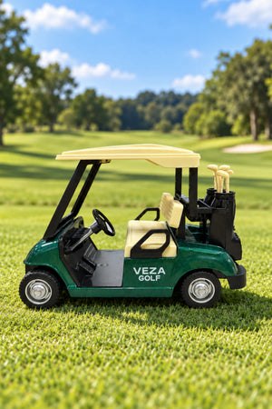 Side view of a green Veza Golf miniature golf cart with a cream roof, matching seats and golf bags on a grassy golf course
