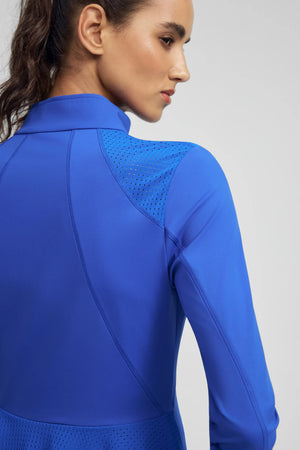 Close-up of VEZA cobalt bloom peplum zip jacket highlighting breathable mesh panel shoulder detail
