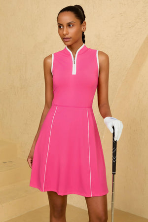 VEZA hot pink sleeveless half-zip golf dress shown from the front, holding a golf club on the course
