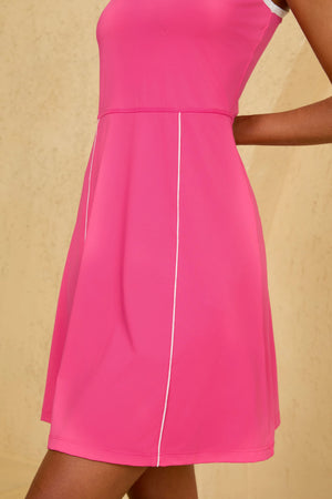 Close-up of VEZA hot pink sleeveless golf dress showcasing the functional pocket design