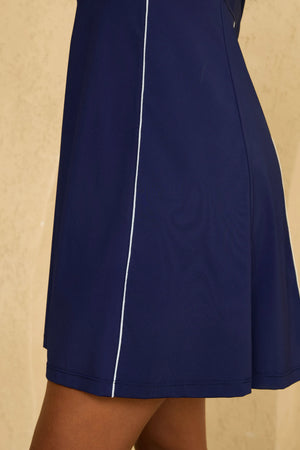 Close-up of VEZA midnight swing navy blue sleeveless golf dress showing the clean A-line hem design