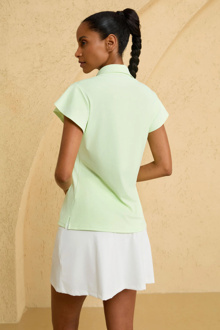 Back view of VEZA fairway mint ruffle-sleeve performance golf polo with a streamlined silhouette