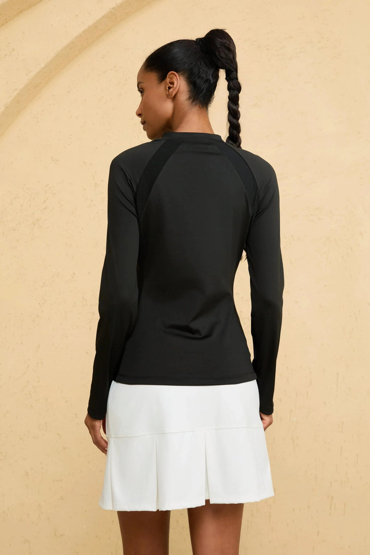 Back view of VEZA women’s black mock-neck performance top with seamless design and UPF 50+ protection