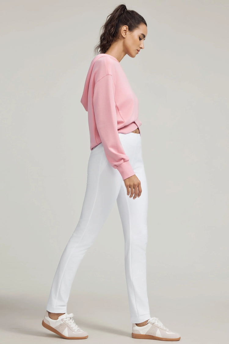 Side view of VEZA cloudline white performance pants featuring ultra-stretch fabric and a streamlined fit