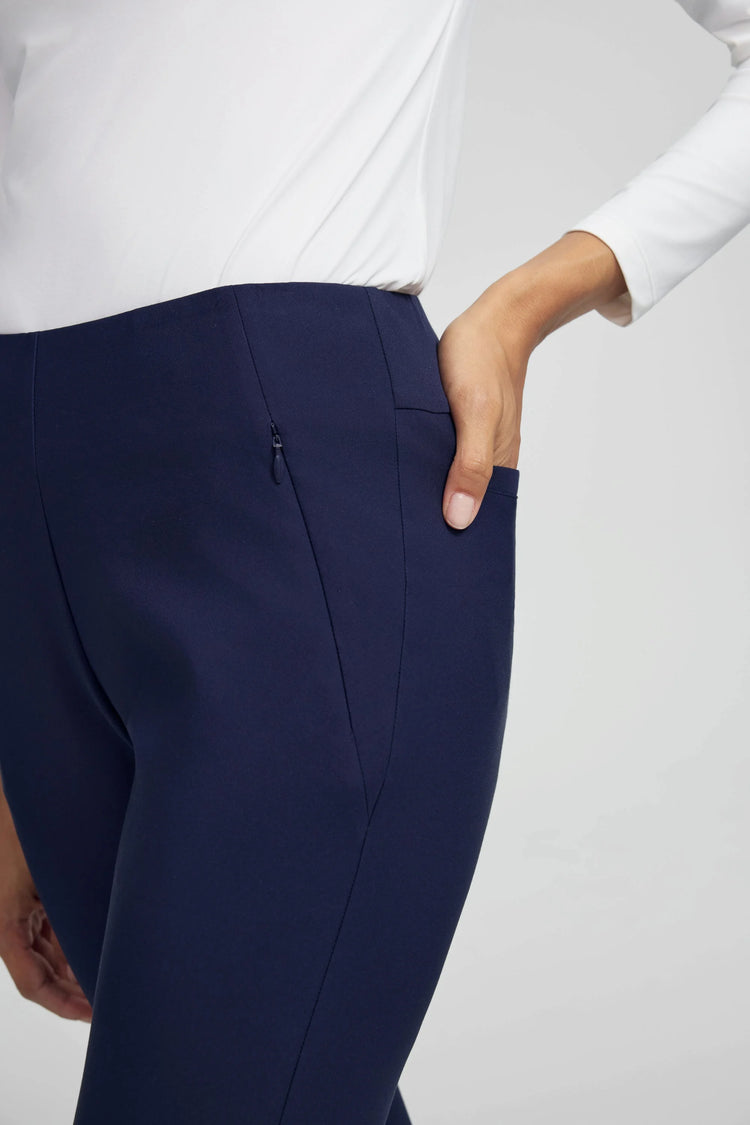 Close-up of VEZA navy blue performance pants highlighting secure zip-pocket construction