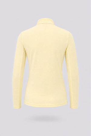 Back view of women’s yellow long sleeve zip-neck golf top with lightweight stretch performance fabric