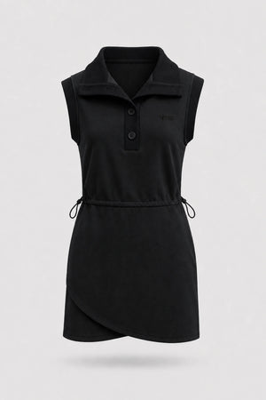 Front view of women's black sleeveless golf dress with folded collar, adjustable drawcord waist and asymmetric wrap hem