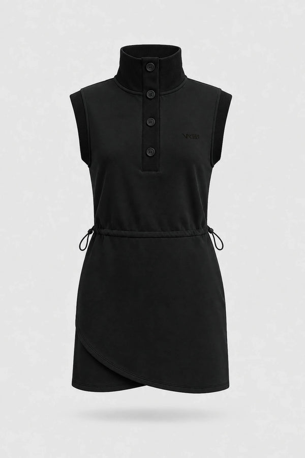 Front view of women's black sleeveless golf dress with buttoned stand collar, drawcord waist and asymmetric wrap hem