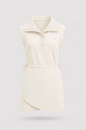 Front view of women's ivory sleeveless golf dress with folded collar, adjustable drawcord waist and asymmetric wrap hem