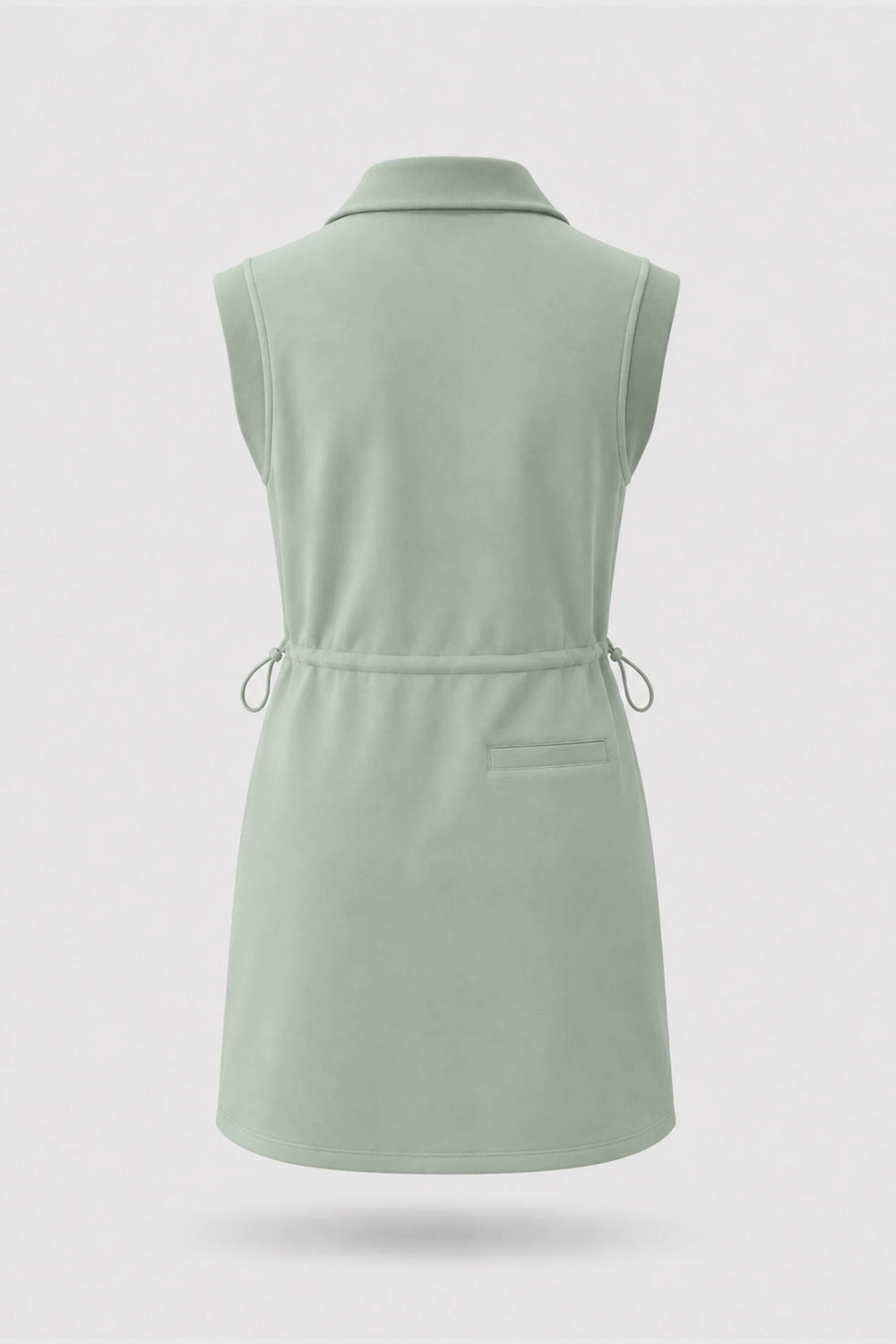 Front view of women's sage green sleeveless golf dress with folded collar, adjustable drawcord waist and asymmetric wrap hem