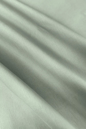 Close-up of the smooth light green fabric texture of the women’s sleeveless golf dress