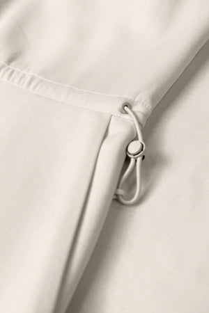 Close-up of the adjustable drawcord waist on the Soft Ivory women’s sleeveless golf dress