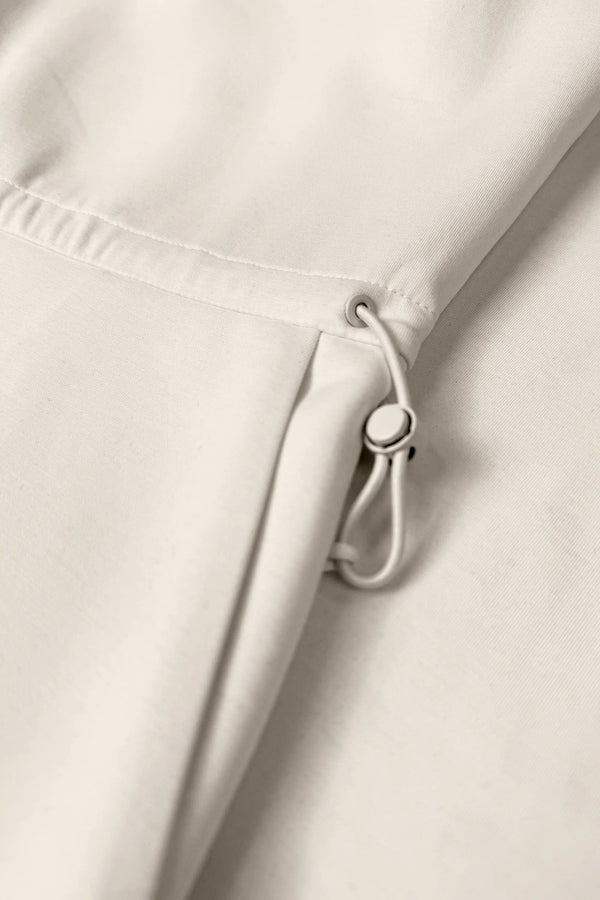 Close-up of the adjustable drawcord waist on the Soft Ivory women’s sleeveless golf dress